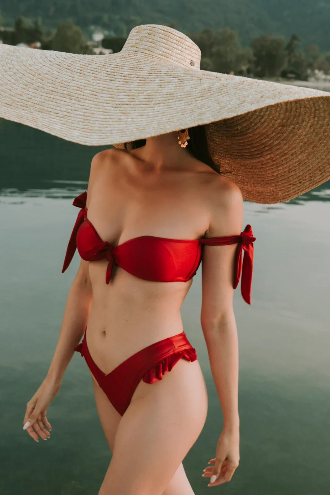 Red bikini swimwear look by the water – Calliope Anemouli