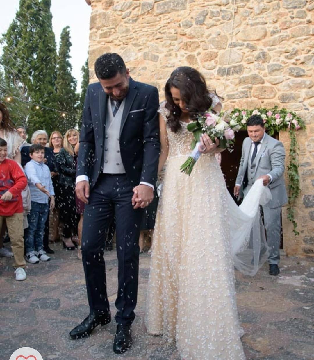 Bride wearing a handcrafted bridal gown by Calliope Anemouli at an outdoor wedding
