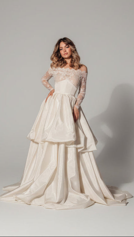 Woman in a white wedding dress standing on a stage 