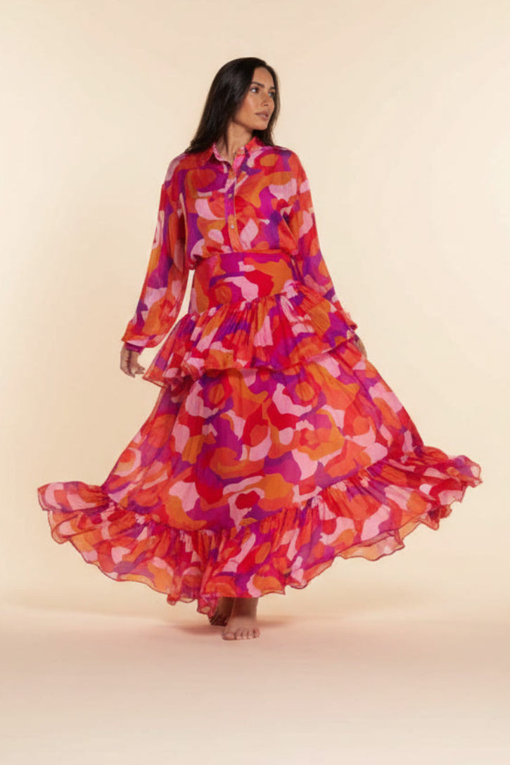 Woman wearing a colorful floral dress on a beige background