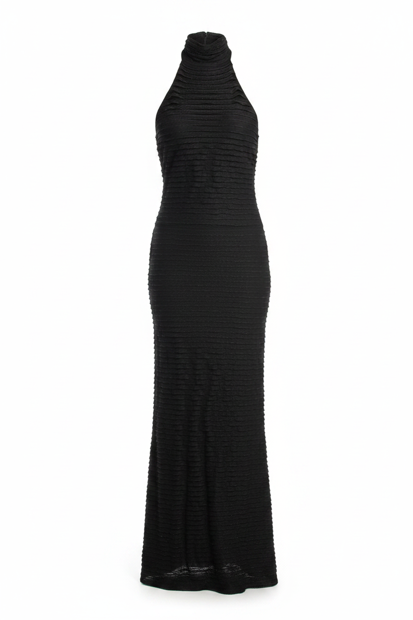 Woman wearing a black halter neck dress against a gray wall.