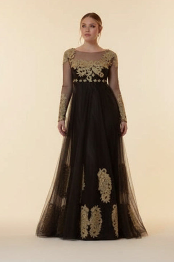 Woman wearing a black evening gown with gold embroidery against a beige background