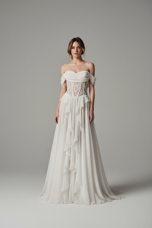 Elysara draped bridal gown by Calliope Anemouli with off-shoulder neckline, transparent lace corset and flowing skirt